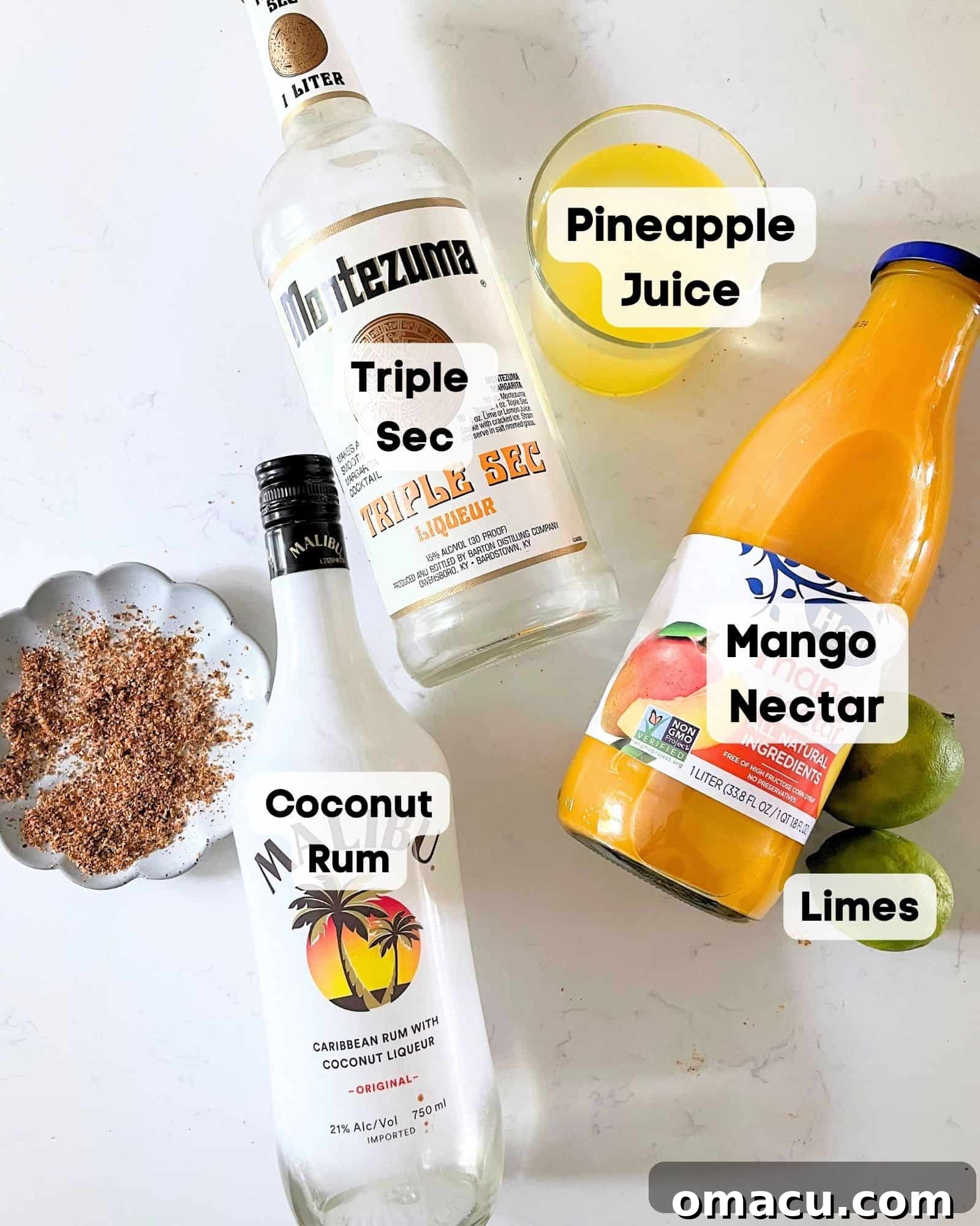 Ingredients to make a mango tango - mango nectar, triple sec, coconut rum, pineapple juice, and lime juice laid out on a surface.
