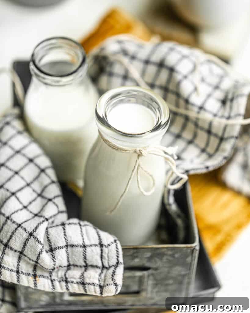 Buttermilk in a clear glass bottle, showcasing its creamy, thick consistency, ready to be incorporated into any recipe.