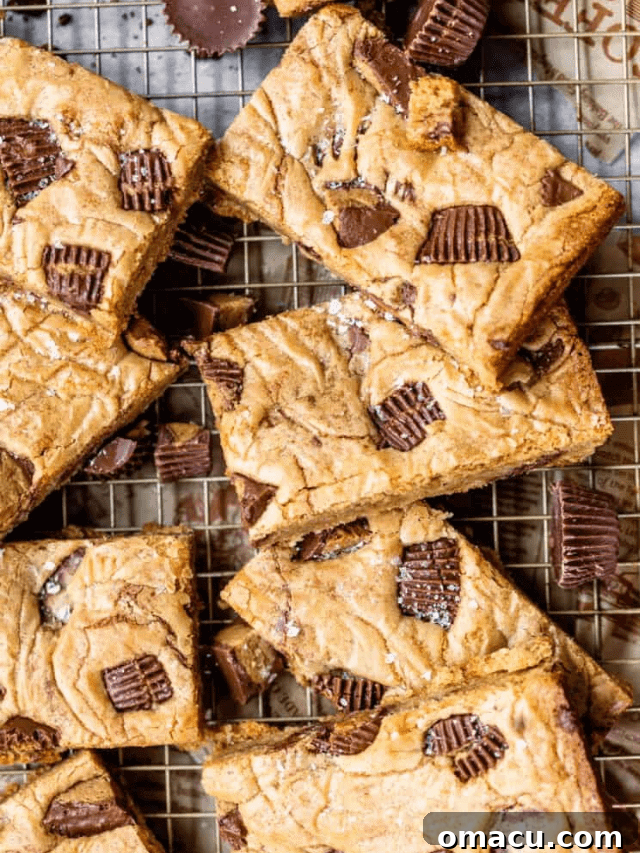 Brown butter peanut butter cup blondies, decadent and rich, cooling on a wire rack, showcasing a perfect bake.