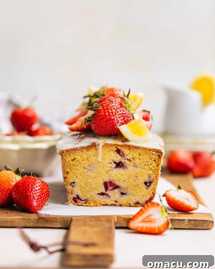 A perfectly sliced loaf of strawberry bread, showcasing the tender crumb and abundant strawberry chunks within, ready to be enjoyed.
