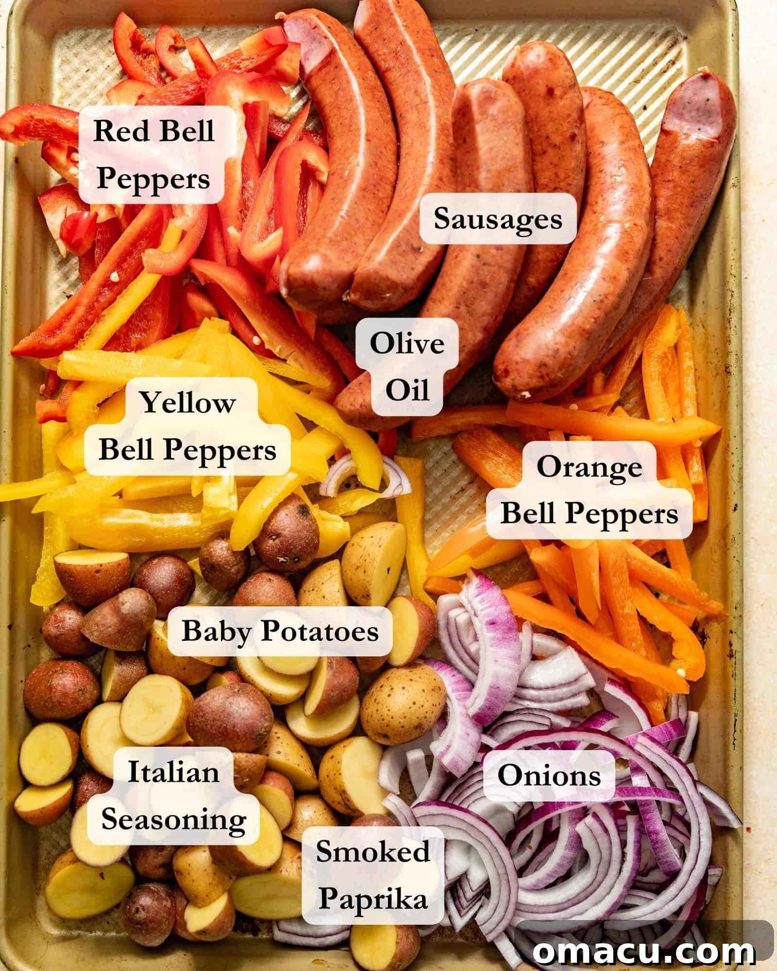 The array of fresh ingredients for sheet pan sausages and peppers: various sausages, bell peppers, onions, baby potatoes, Italian seasoning, smoked paprika, and olive oil.