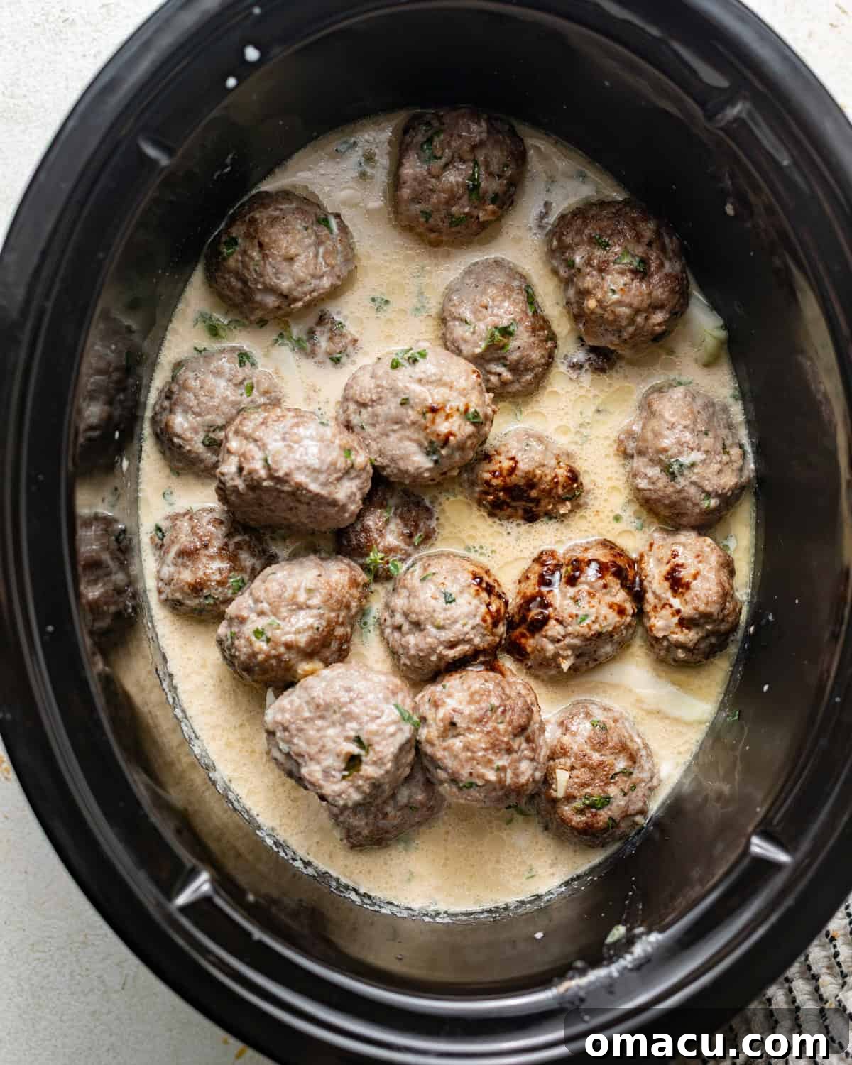 meatballs and gravy in a slow cooker.