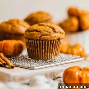 A baked pumpkin muffin on a white table, ready to be served and enjoyed.