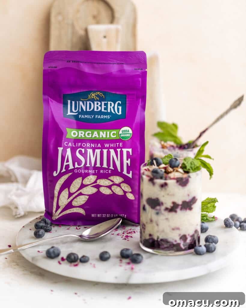 A bag of Lundberg Family Farm's Organic White Jasmine Rice positioned on a rustic serving tray, highlighting the quality ingredient.