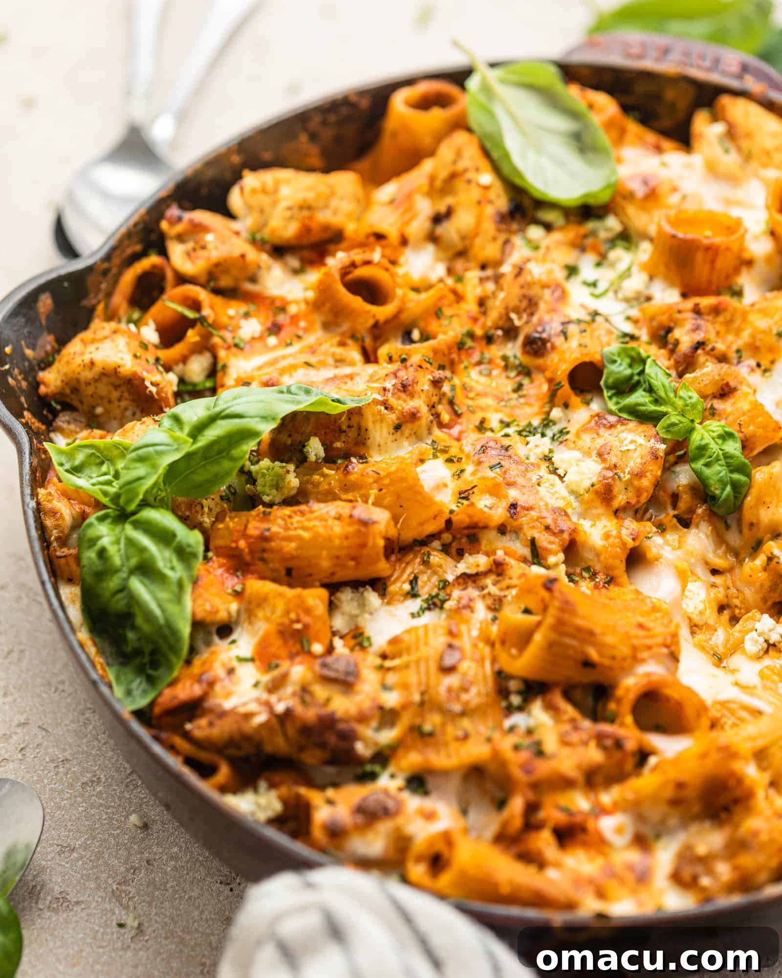 Close-up of buffalo chicken pasta in a skillet, showcasing the creamy sauce and melted cheese