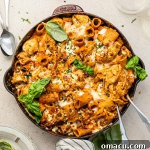 buffalo chicken pasta in a large skillet garnished with basil
