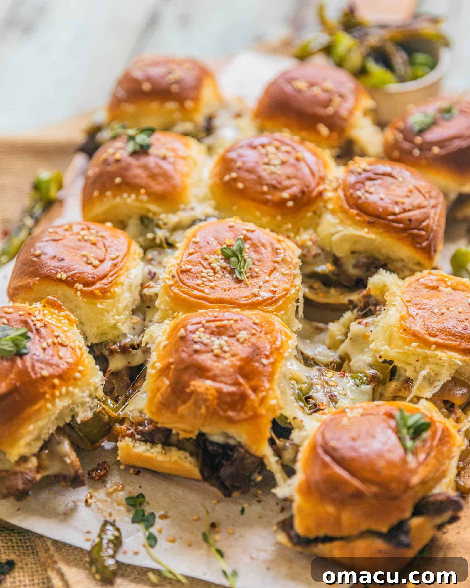 Philly Cheesesteak Sliders pulled apart and served on a rustic wooden serving tray