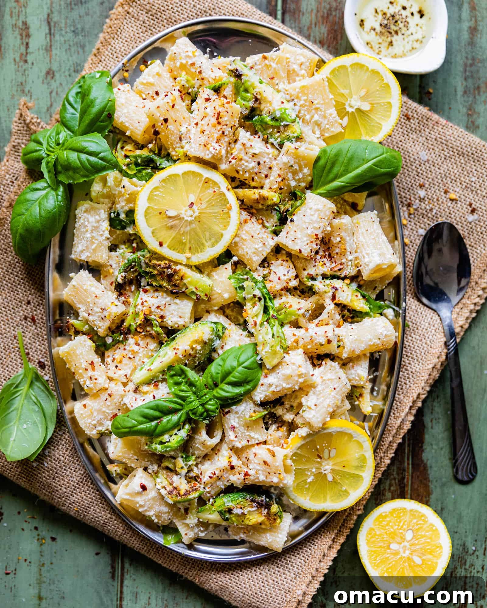 A beautifully plated lemon ricotta pasta dish, garnished with fresh basil and lemon slices, ready to be enjoyed.