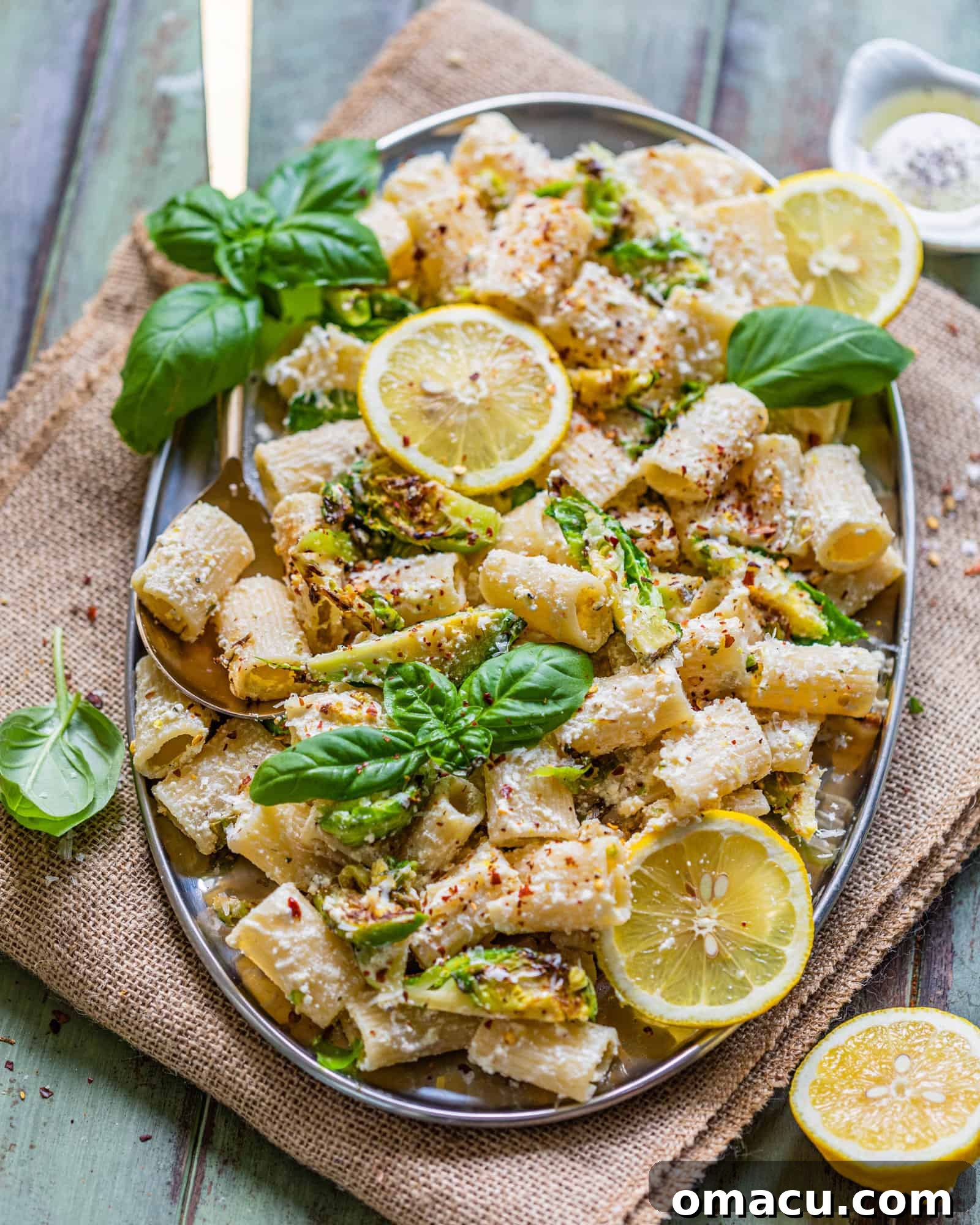 A family-style serving of lemon ricotta pasta, elegantly presented on a silver serving tray, inviting everyone to partake.