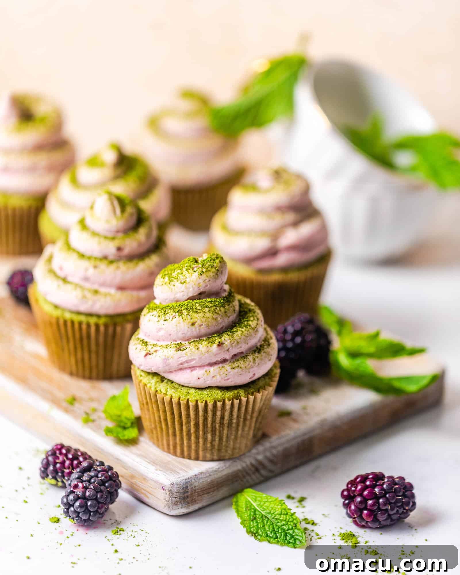 cupcakes on a table with berries