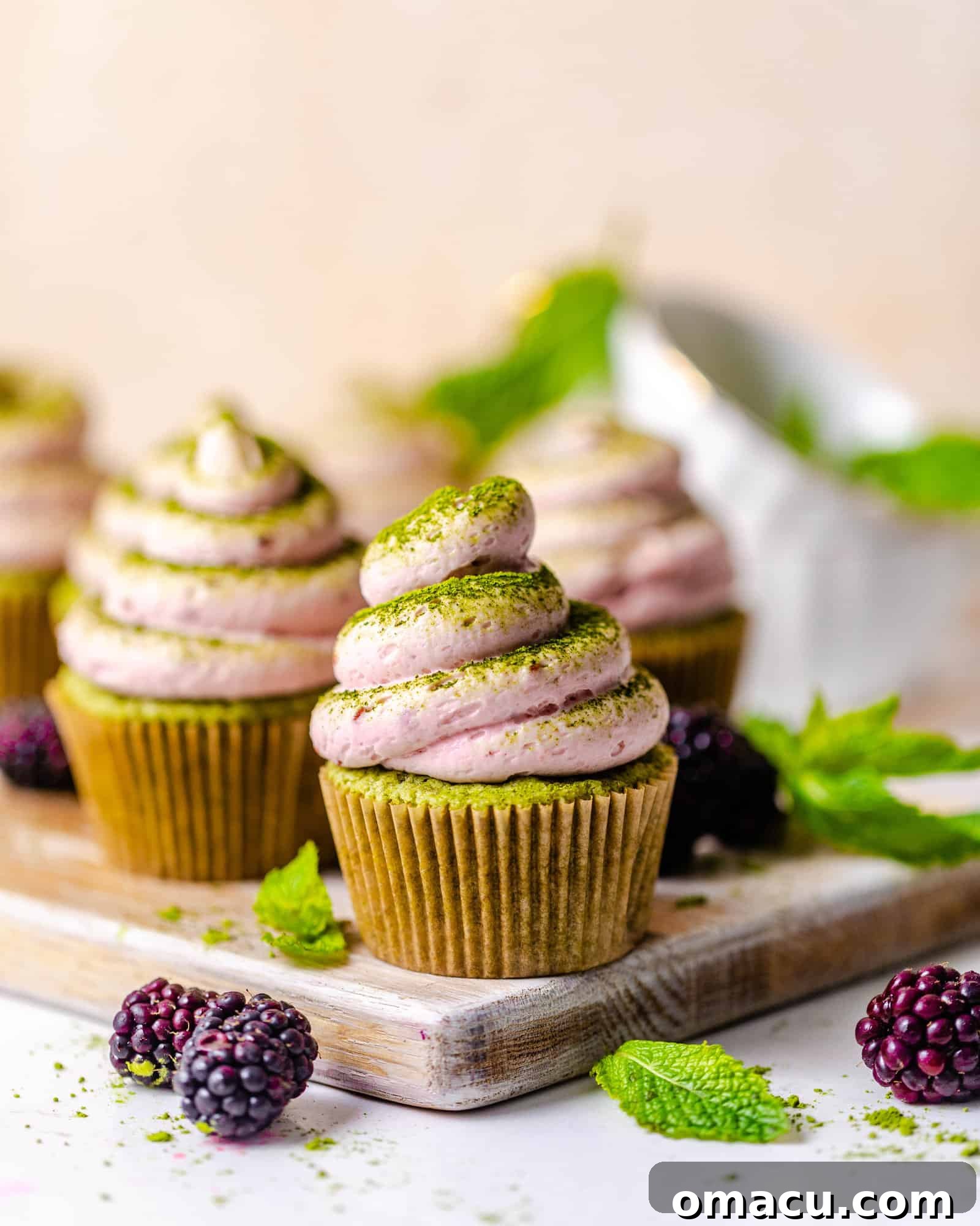 cupcakes on a table with berries