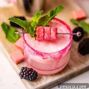 Pink starburst drink on a serving board with berries