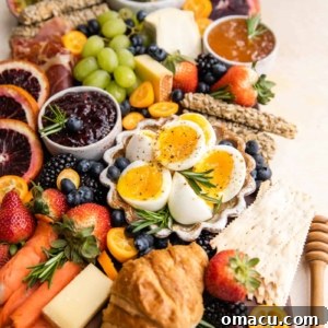 A beautifully arranged summer charcuterie board featuring a variety of fresh ingredients, cheeses, and meats.