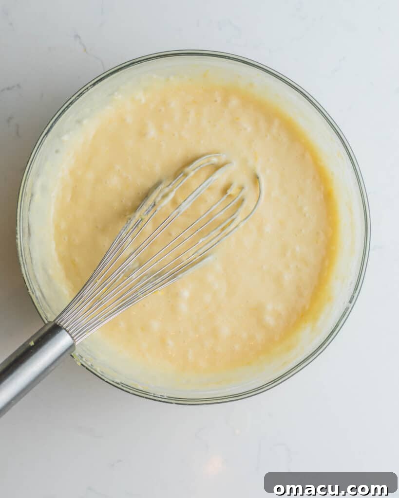 Step-by-step image: The finished cupcake batter resting in a large mixing bowl, perfectly smooth and ready for baking.
