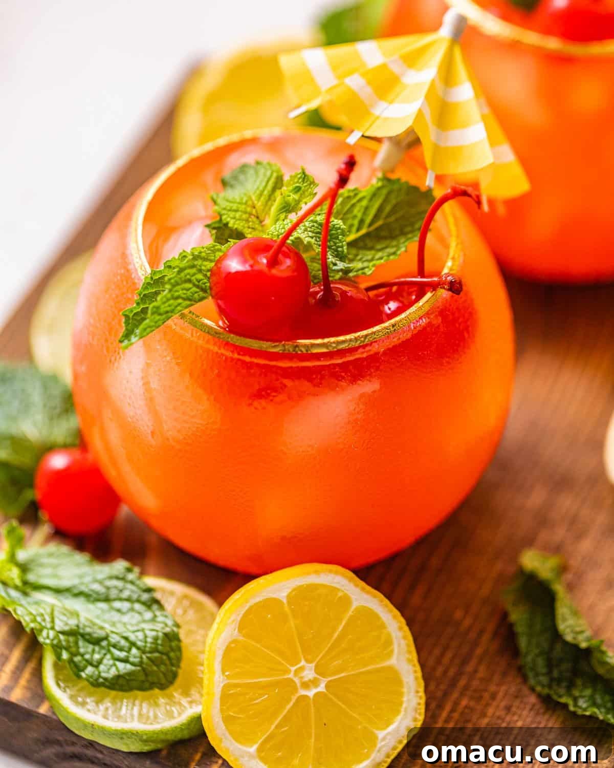 An inviting close-up photo of a glass filled with a bright red and orange Bahama Mama cocktail, showing off its vibrant colors.