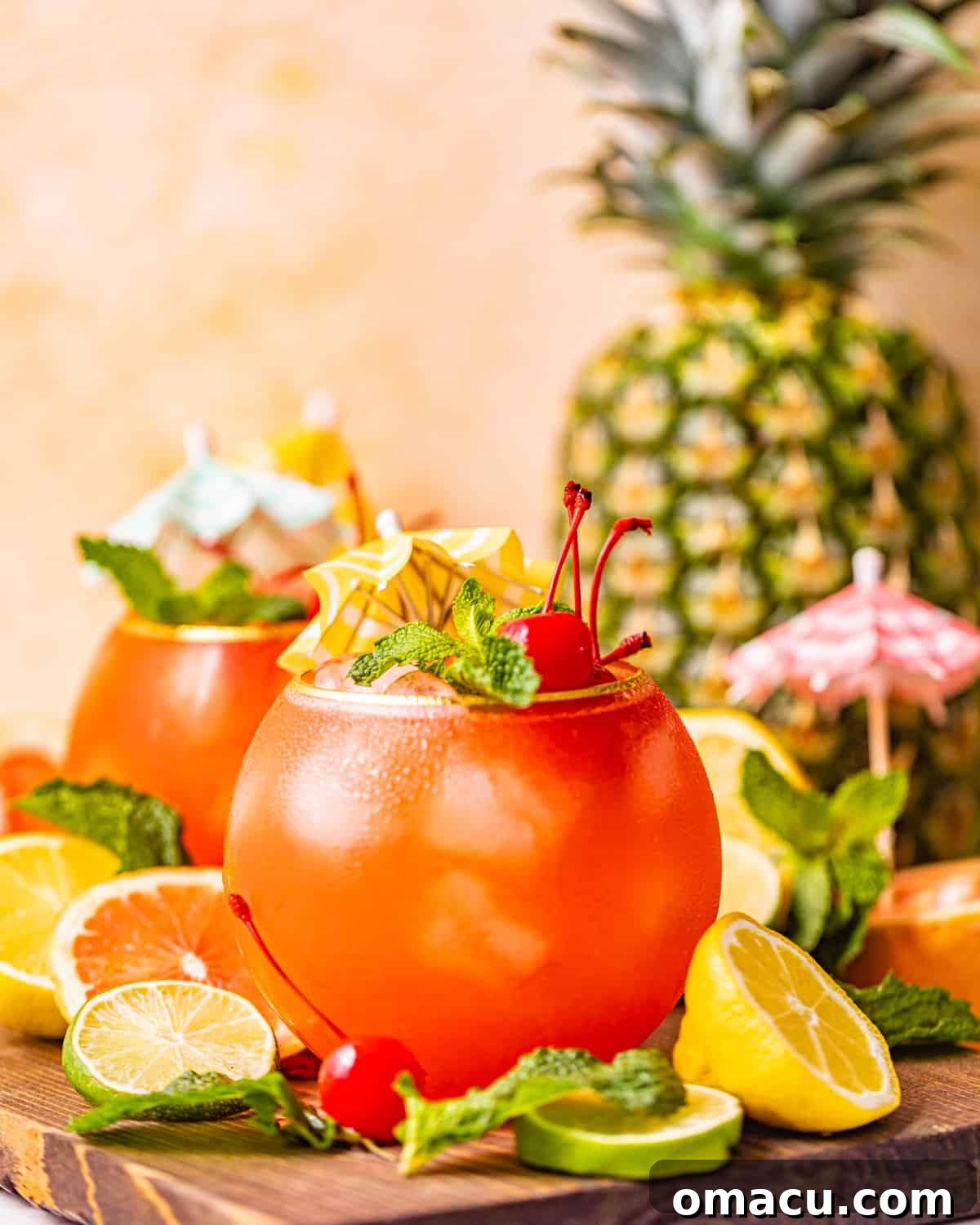 A Bahama Mama cocktail presented on a rustic brown tray, garnished with vibrant sliced lemons and limes, enhancing its fresh appeal.