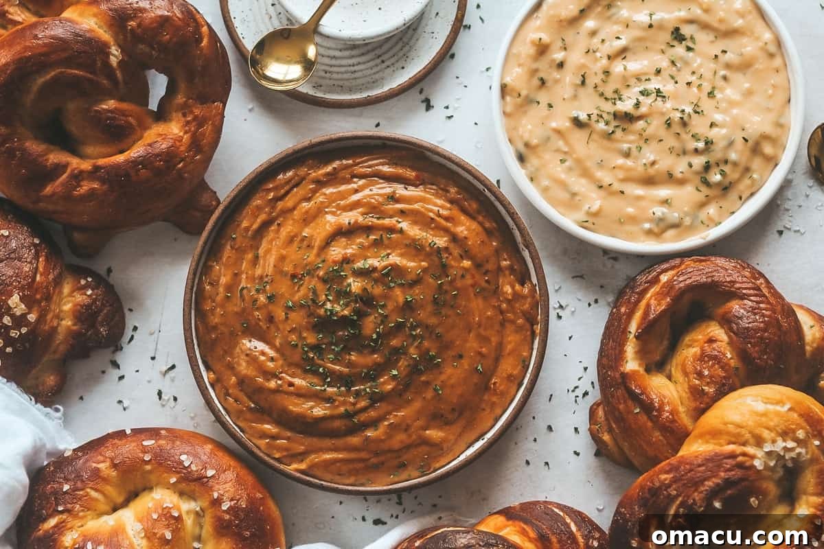 Close-up of creamy beer cheese dip with brioche pretzels arranged around it, perfect for dipping.