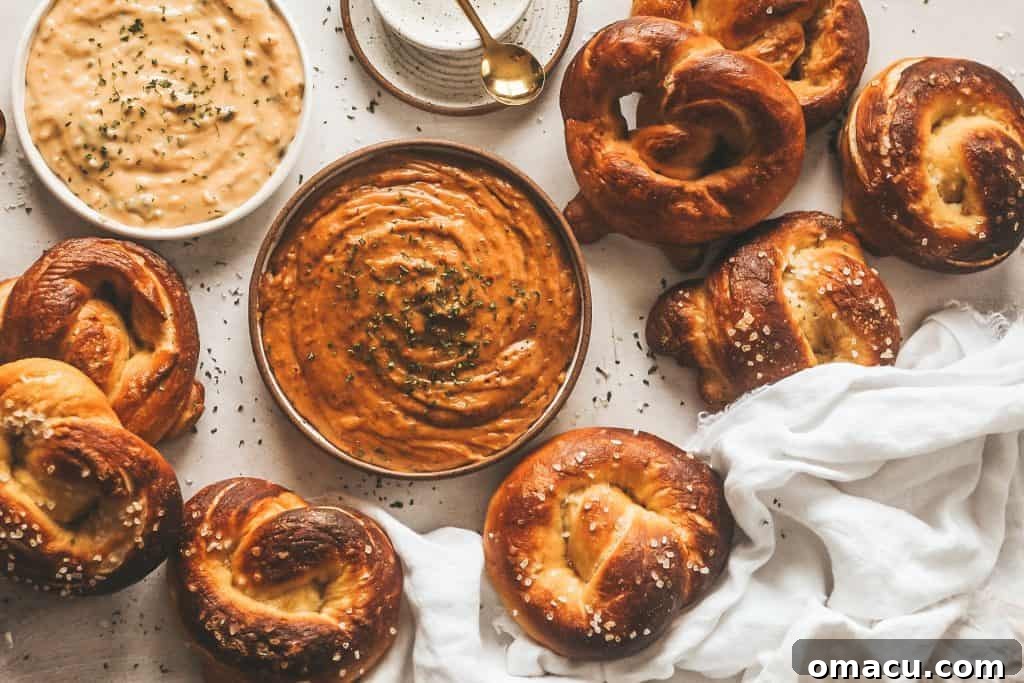 Warm, freshly baked brioche pretzels ready for dipping into the rich smoked gouda beer cheese.