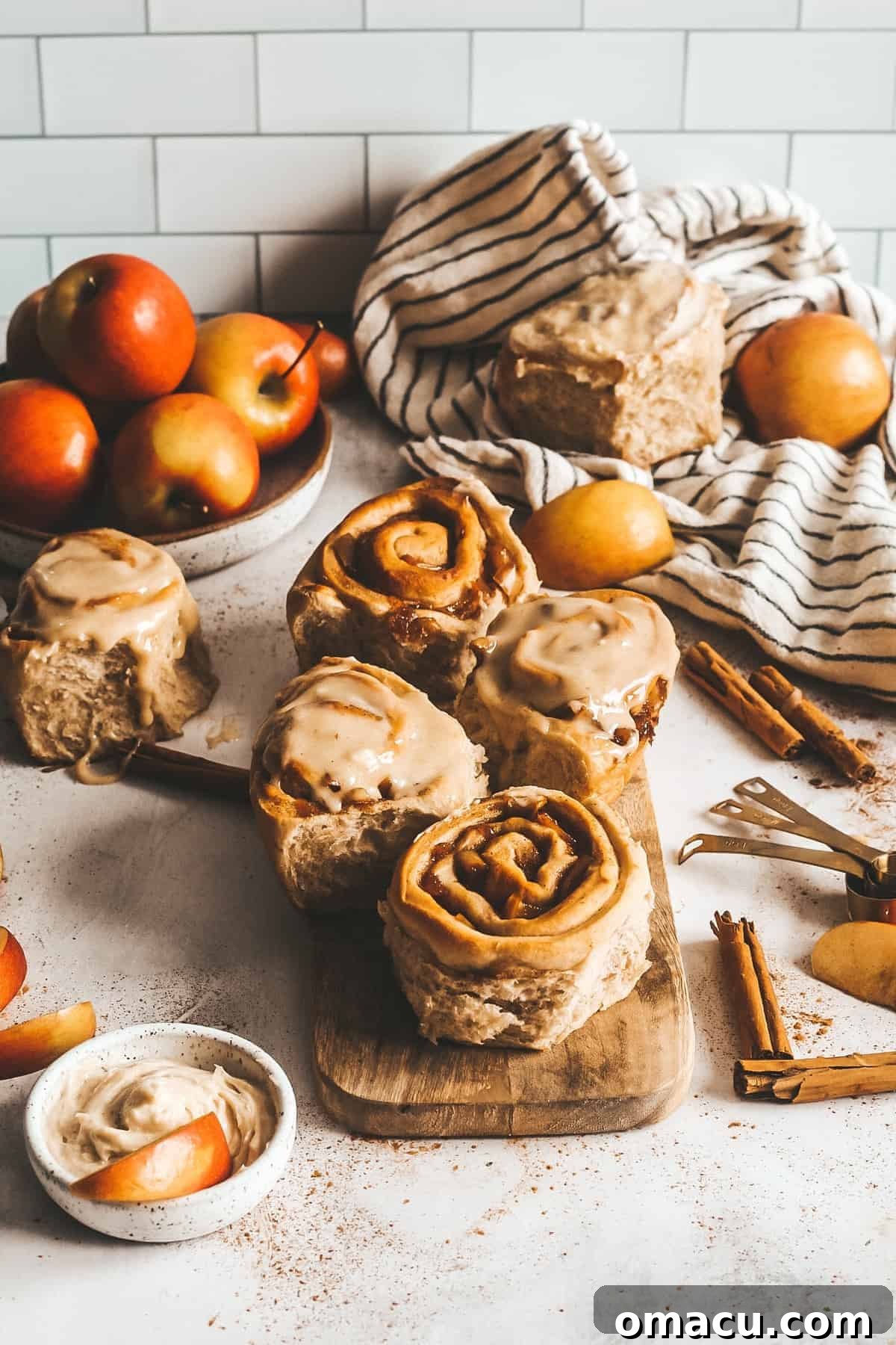 Freshly baked Apple Cider Cinnamon Rolls with generous browned butter cream cheese frosting, ready for autumn enjoyment.