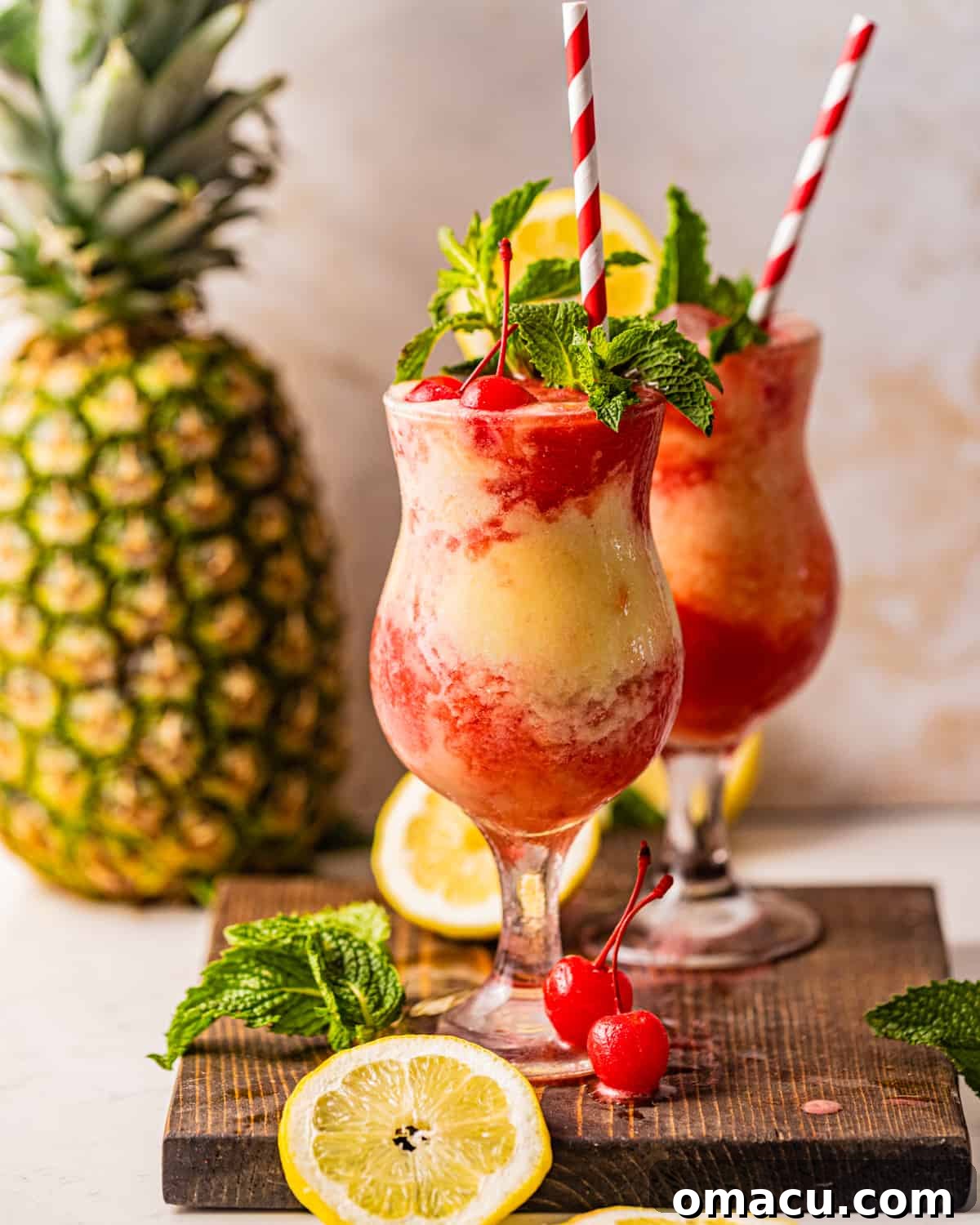 Two vibrant Miami Vice Drinks garnished with red and white straws, perfect for a tropical escape.