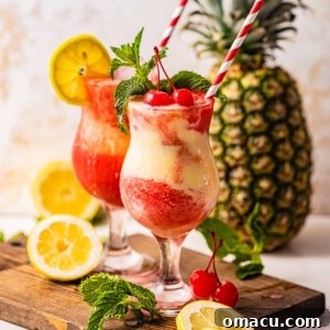 Two Miami Vice Drinks on a serving tray in front of a pineapple.
