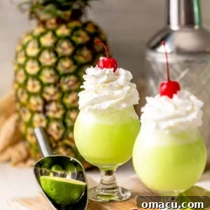 Two Scooby Snack Shots in front of a pineapple.