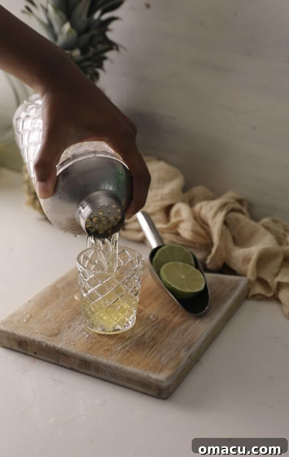 A perfectly mixed Water Moccasin shot being strained from a cocktail shaker into a shot glass, ready for serving.