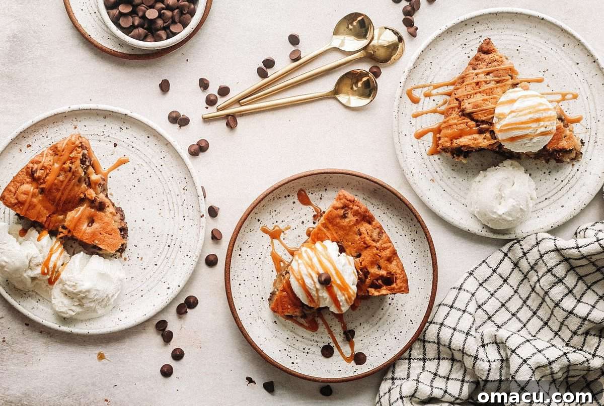 A generous slice of warm Triple Chocolate Chip Skillet Cookie, gooey and rich, ready to be enjoyed.