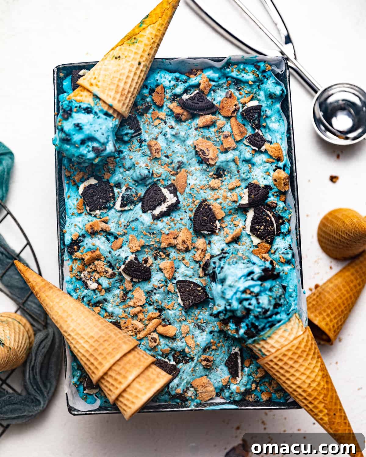 monster ice cream in a pan surrounded by ice cream cones. 