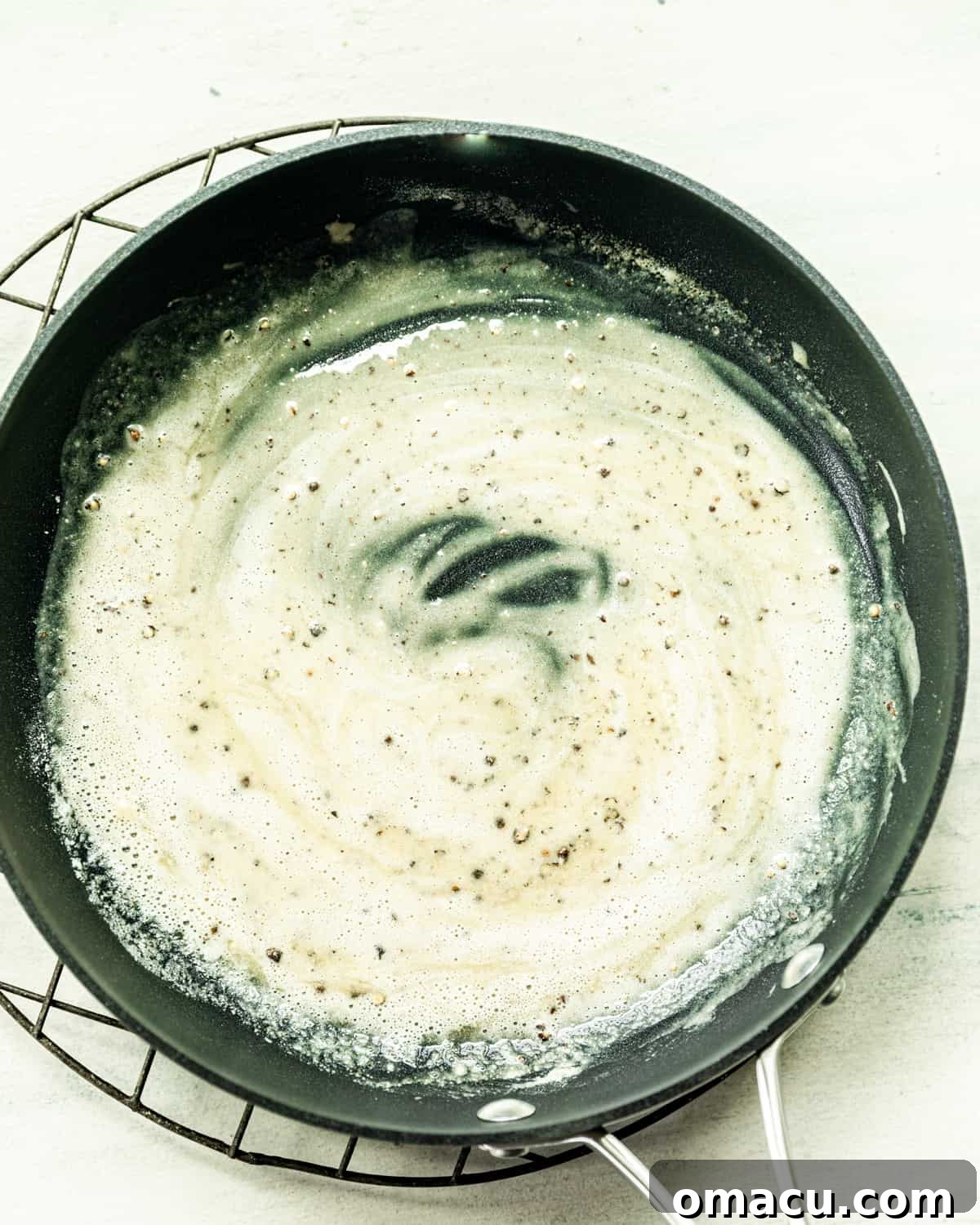 Four steps showing ingredients, flour, milk, pepper, and cheese in a pan, followed by gnocchi being added to the sauce.