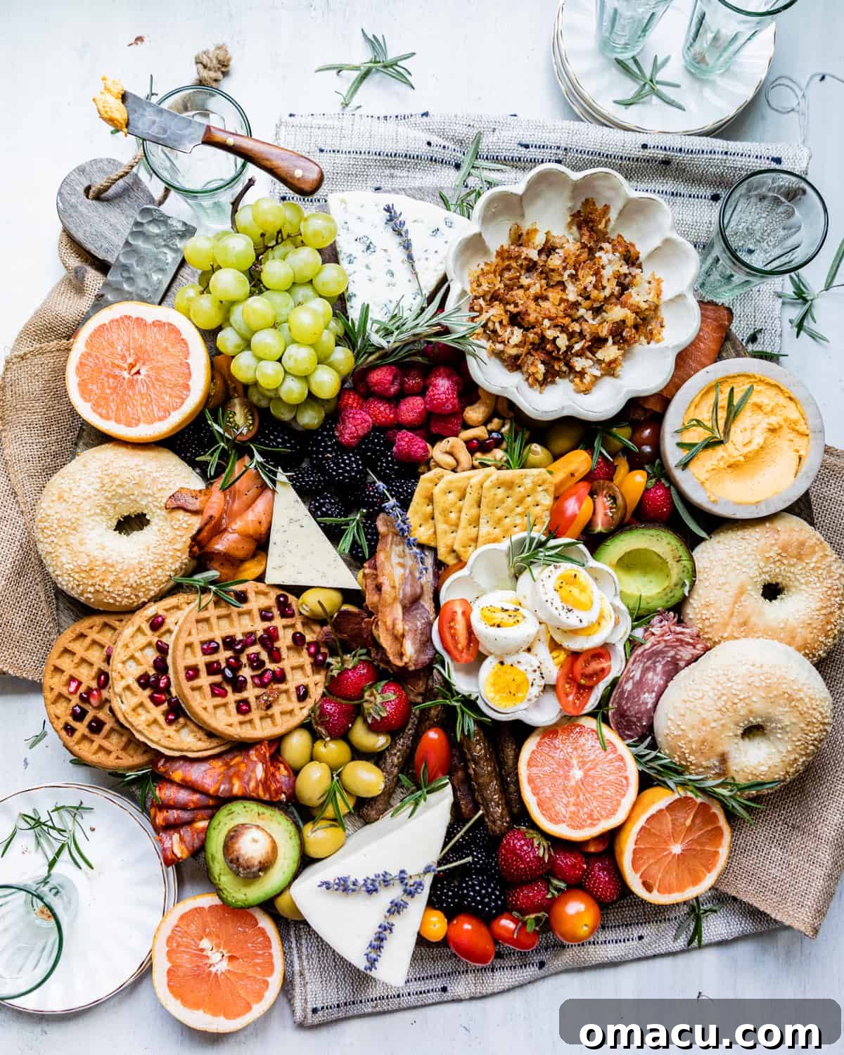 An overhead view of a beautifully assembled brunch charcuterie board, showcasing a wide array of breakfast items.