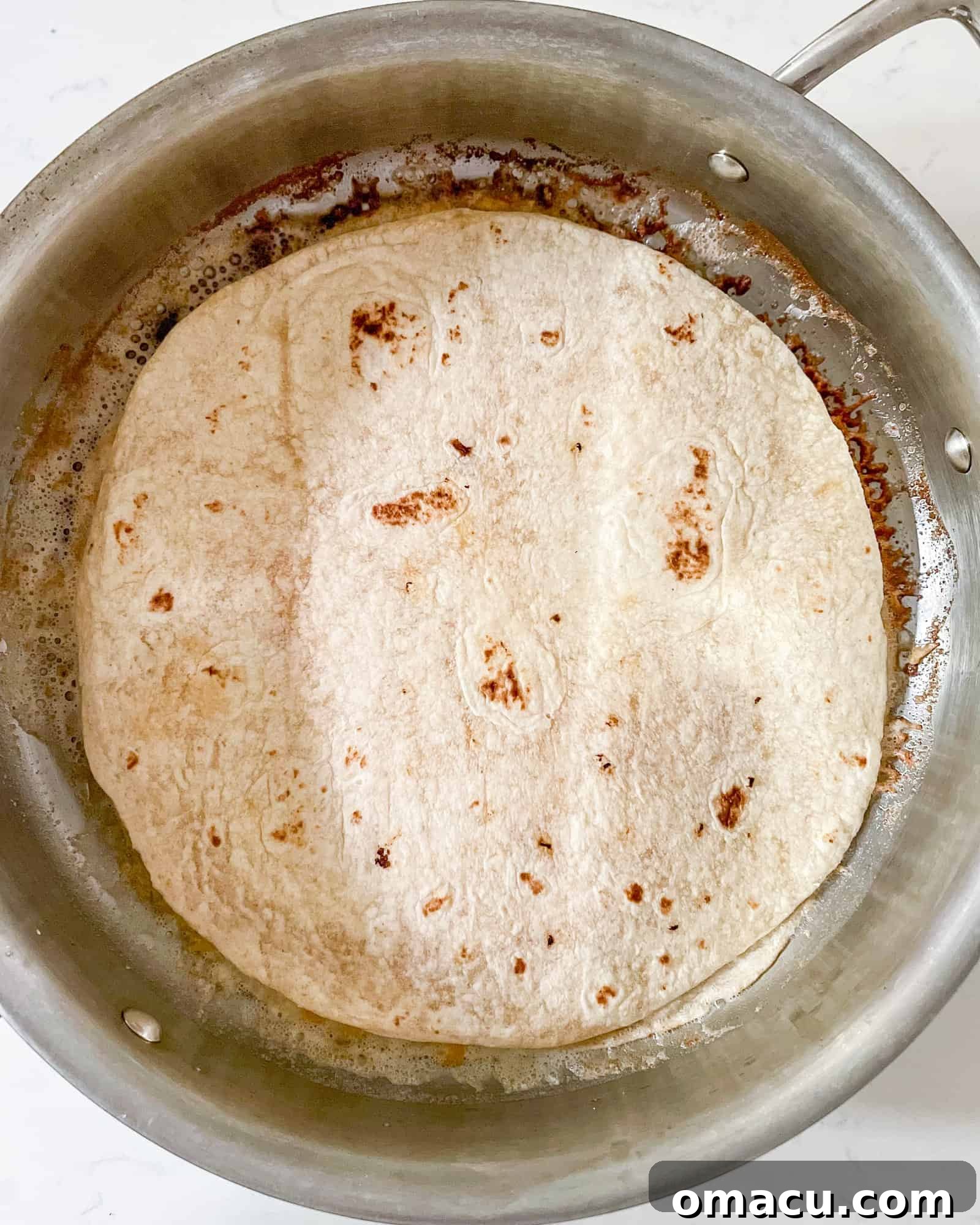 cheese quesadilla in a frying pan.