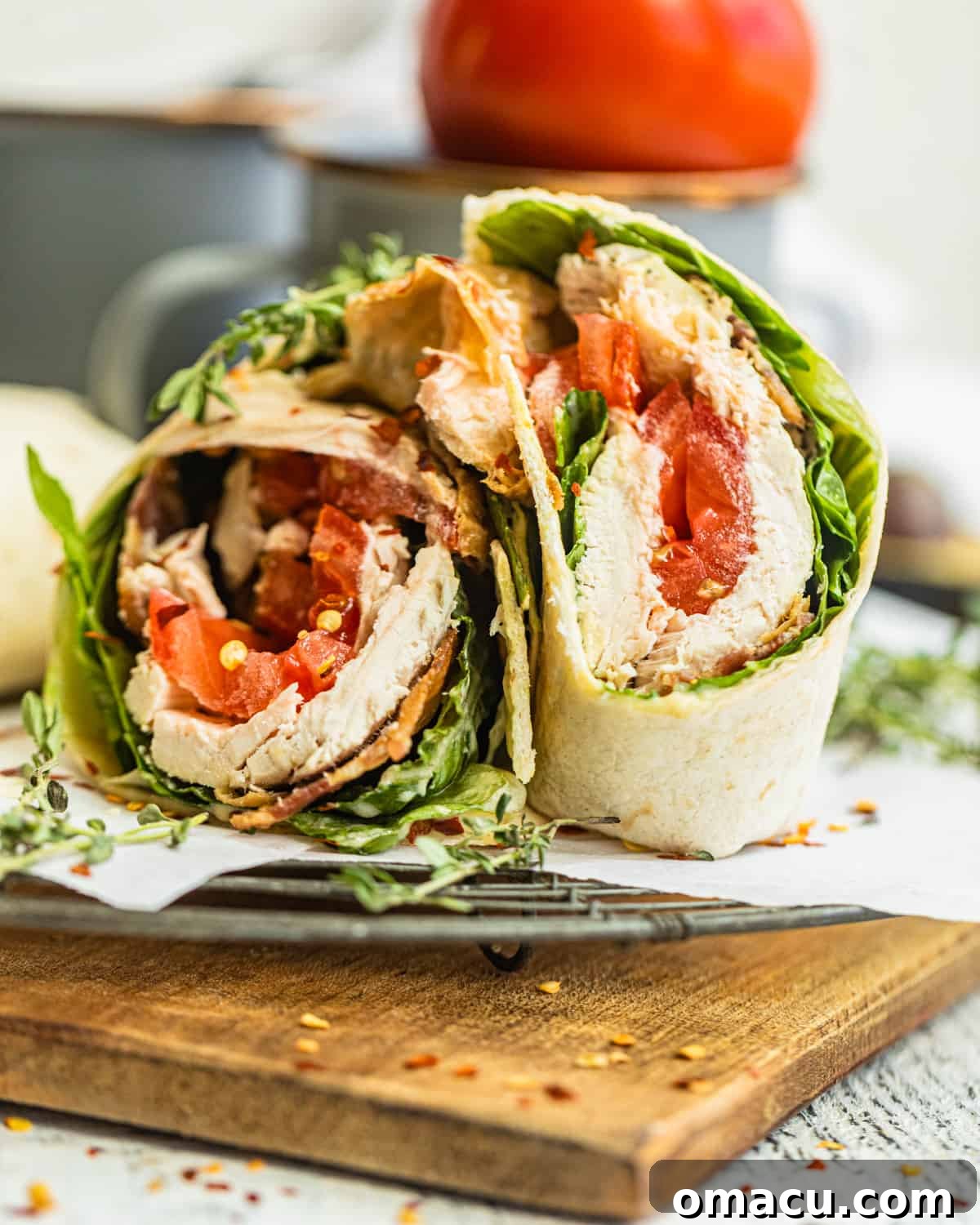 An appetizing close-up photo of multiple chicken bacon ranch wraps arranged on a serving board, ready to be enjoyed.