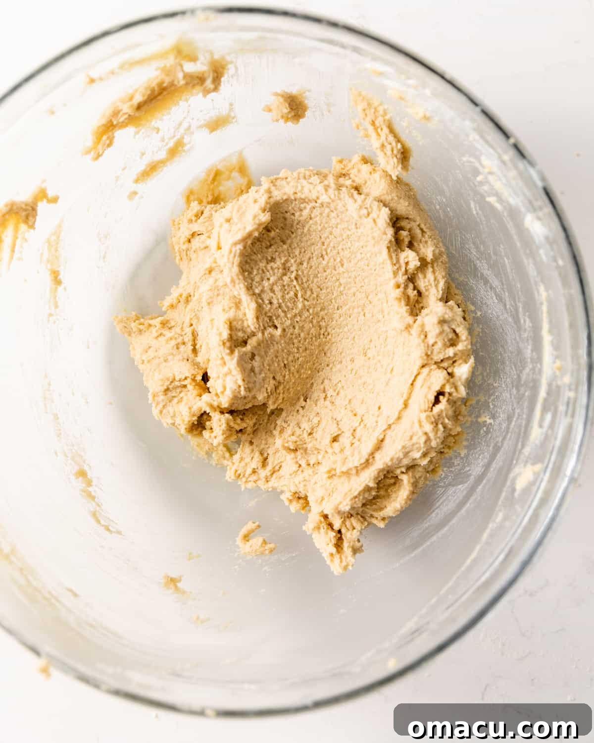 Blue Cookie Monster cookie dough batter in a mixing bowl, showcasing its smooth consistency.
