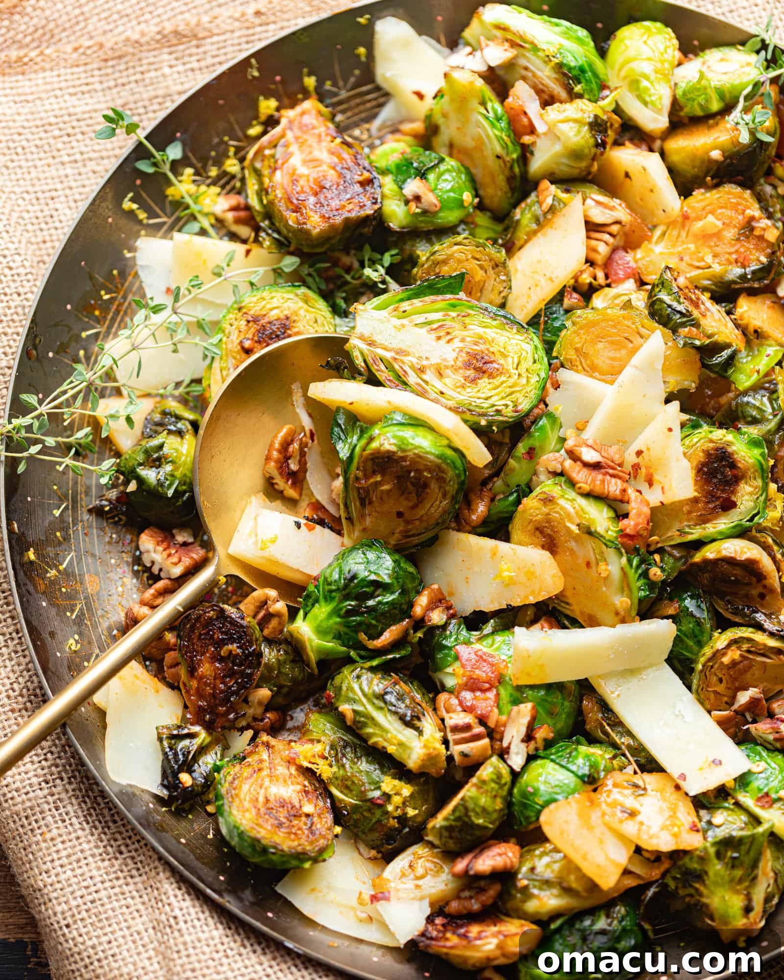 A golden serving bowl brimming with glistening honey sriracha brussels sprouts, ready to be served.