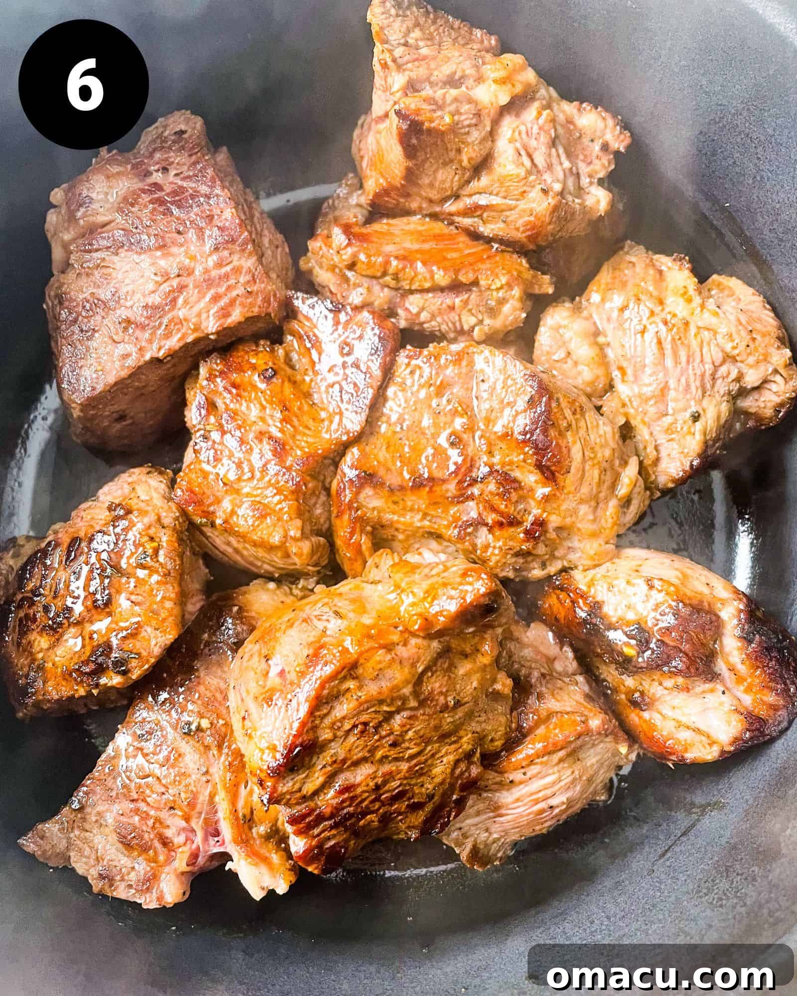 seared chuck roast in a pot, nicely browned on all sides.