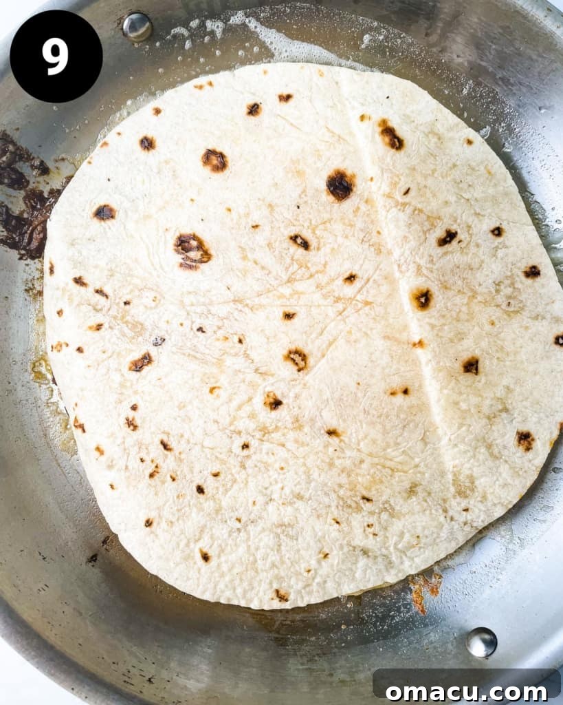 a finished birria quesadilla in a pan, perfectly golden and crispy.