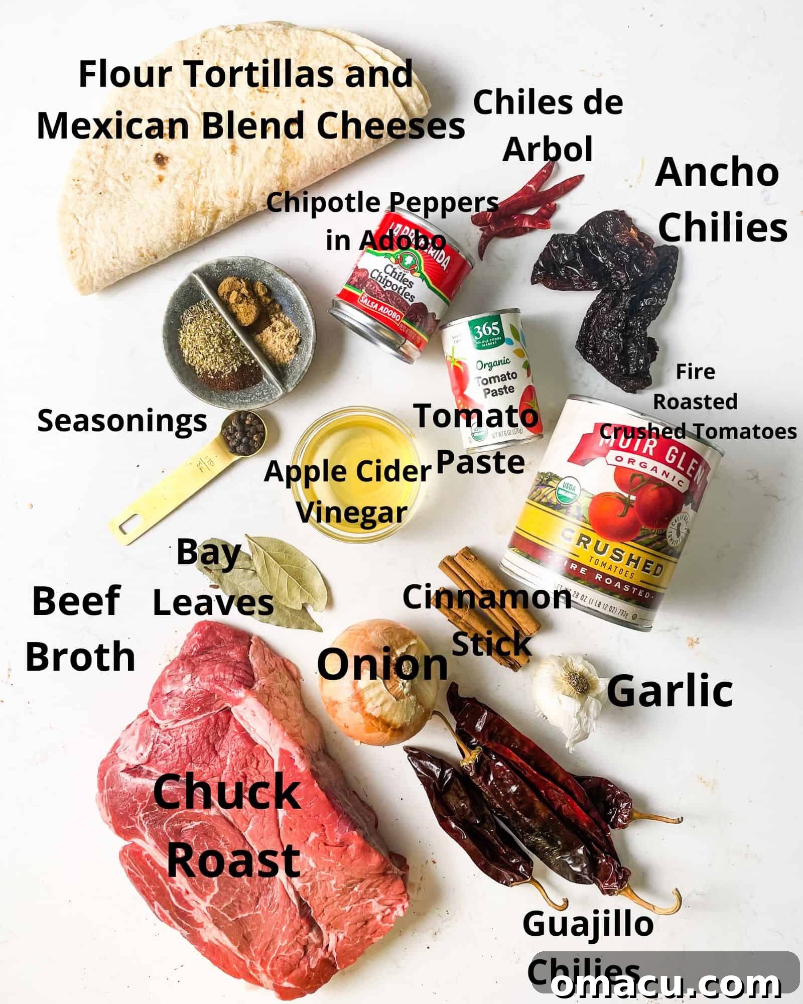 ingredients to make birria quesadillas - chuck roast, beef broth, onion, garlic, bay leaves, seasonings, cinnamon sticks, guajillo chilies, crushed tomatoes, tomato paste, ancho chilies, chipotles in adobo, chiles de arbol, cheese, and tortillas laid out.