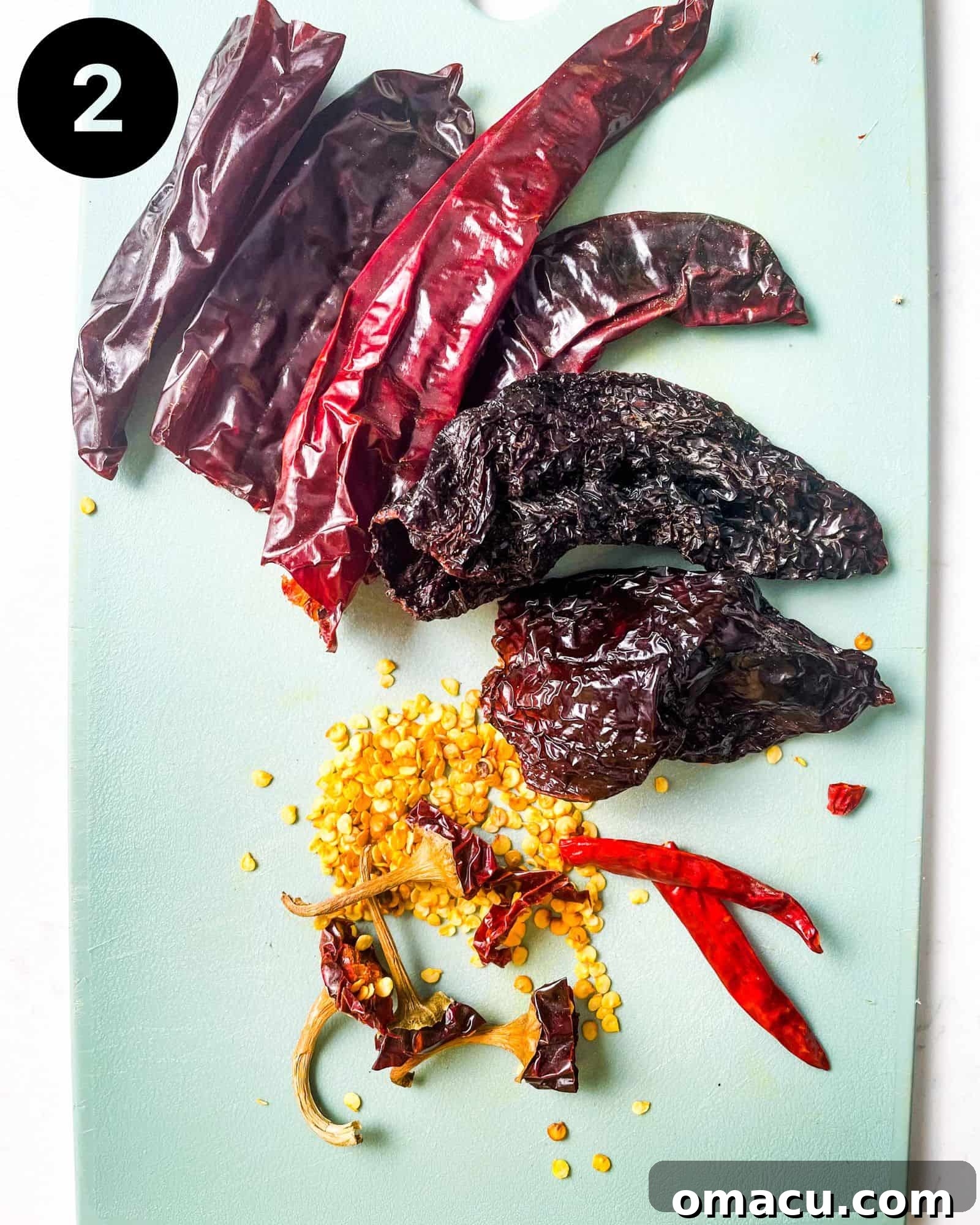 chilies on a cutting board with the seeds removed, preparing for toasting.