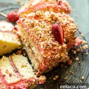 an up close photo of strawberry crunch cake, showing its tempting layers.