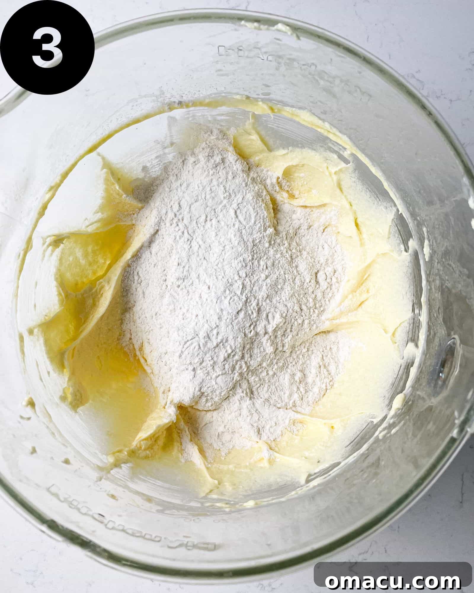 Wet ingredients mixed together in a bowl with half of the dry ingredients for the cake batter.