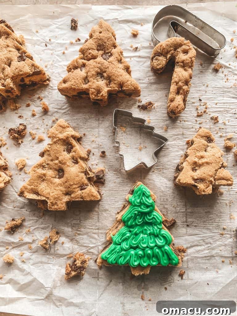 Partially iced Christmas tree cookie showing the green icing base