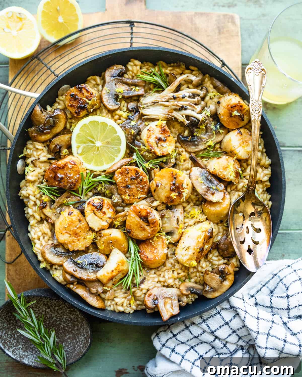 Mushroom Risotto with Scallops resting in a pan on a cooling rack.
