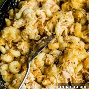 Creamy, golden smoked mac and cheese served in a rustic skillet, topped with a crunchy breadcrumb crust.