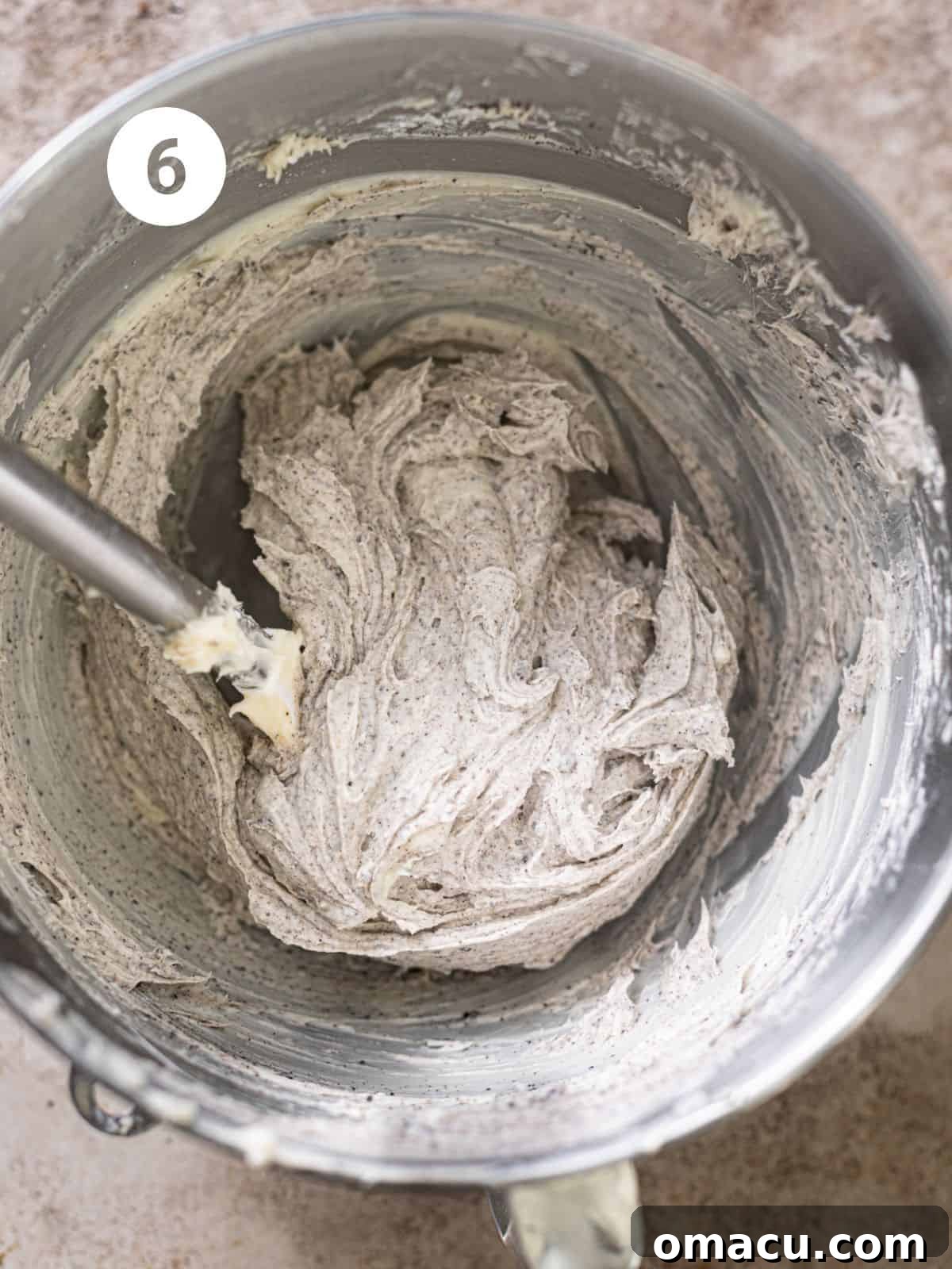 Lush Oreo cream cheese frosting in a mixing bowl, smooth and ready to be spread.