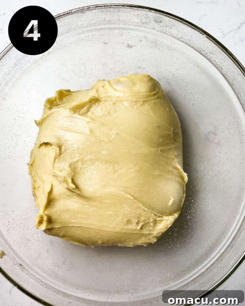 Brioche dough in a bowl, covered for its first rise.