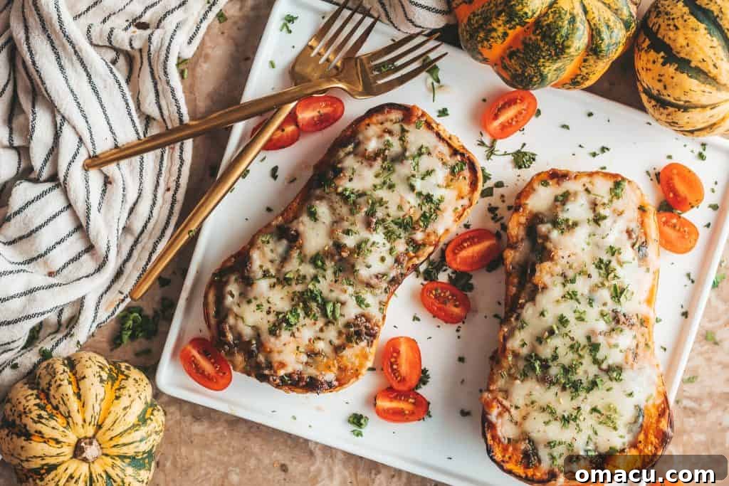 A trio of loaded butternut squash boats presented on a wooden board, garnished with fresh herbs, ready to be served.