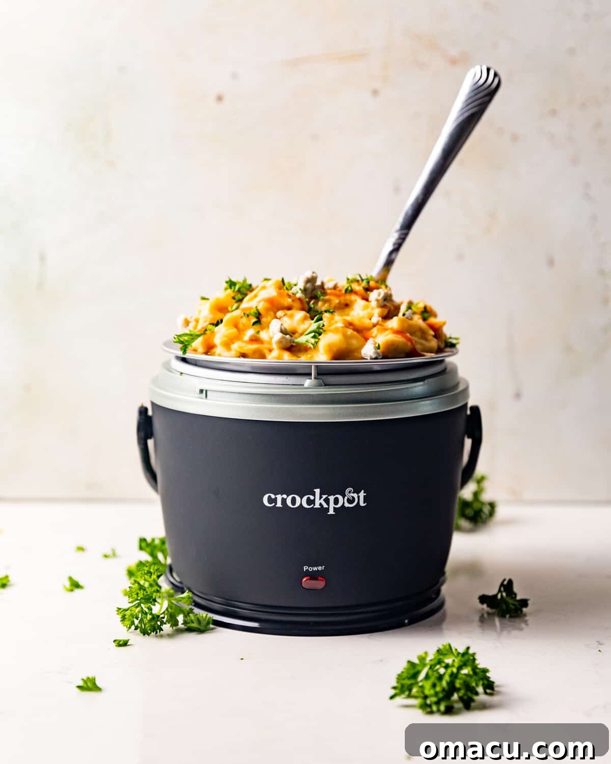 Individual serving of Crockpot Buffalo Chicken Mac and Cheese in a small lunch crockpot, ready to eat.