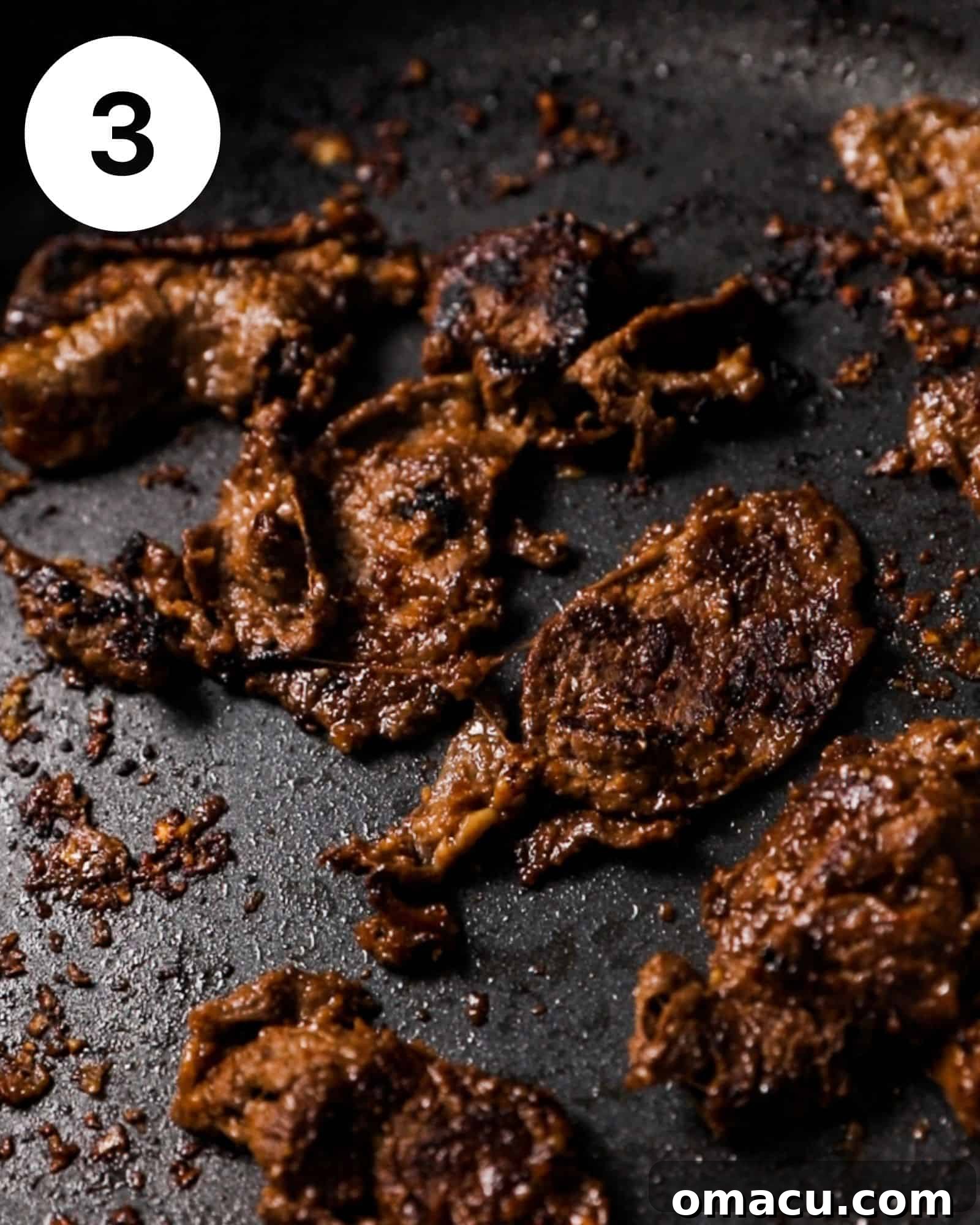 Thin strips of marinated beef sizzling and browning in a hot pan, demonstrating the cooking process for bulgogi.