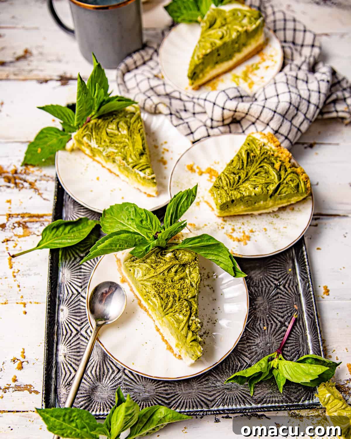 Multiple slices of matcha cheesecake beautifully presented on individual plates.